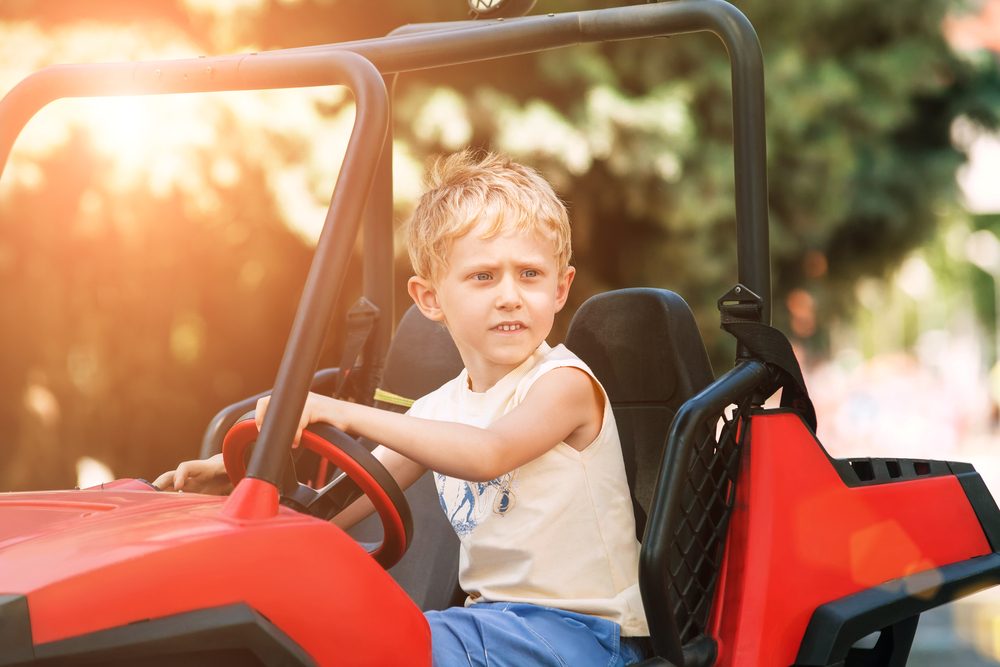 A child driving an electric go-kart