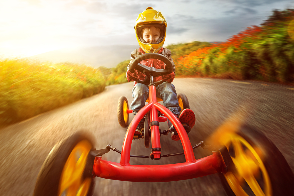 Child riding a pedal-powered go-kart