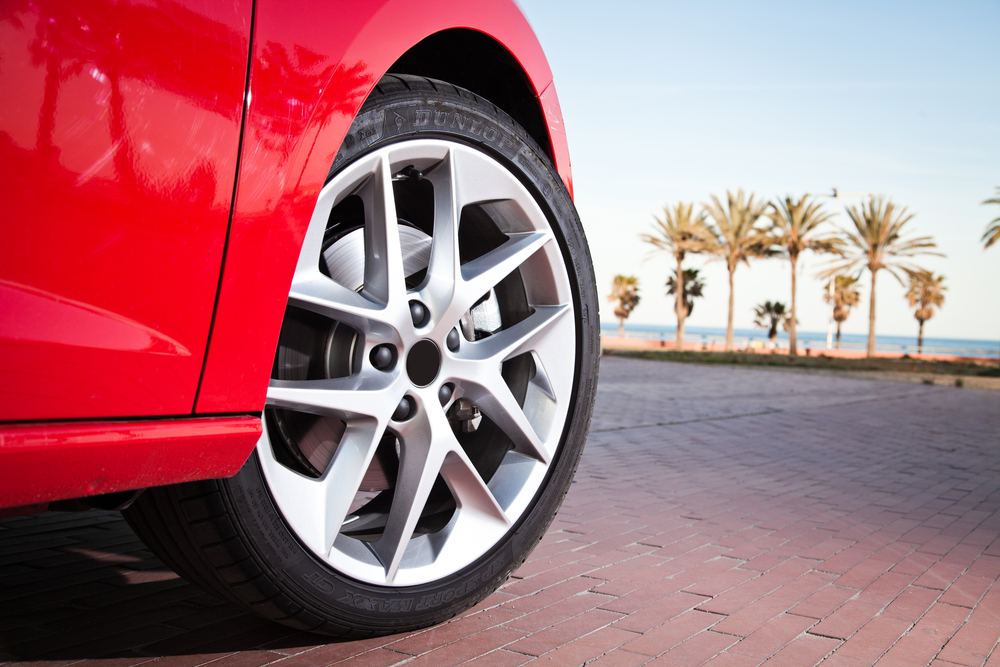 close up car wheel near beach