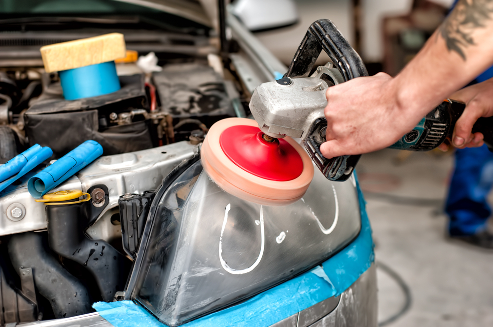 Buffing a car headlight with a giant grinder buffer