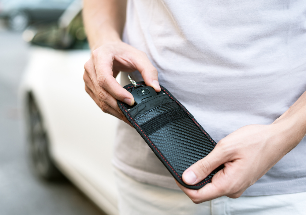 man putting key fob in pouch