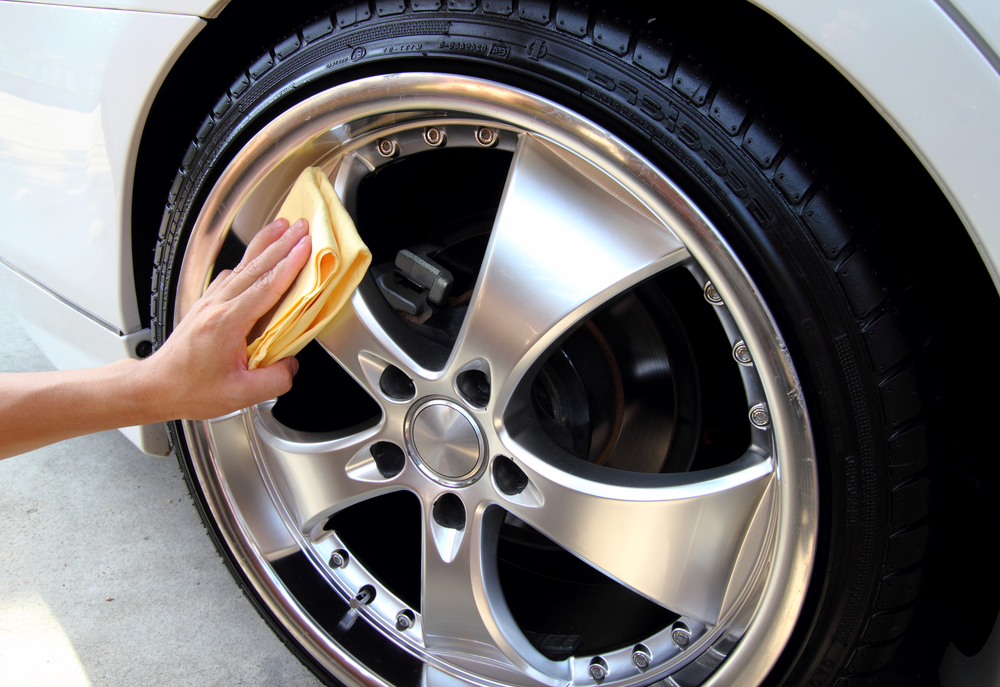 woman buffing chrome polish on wheels