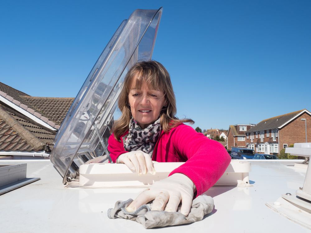 A lady cleaning her RV roof