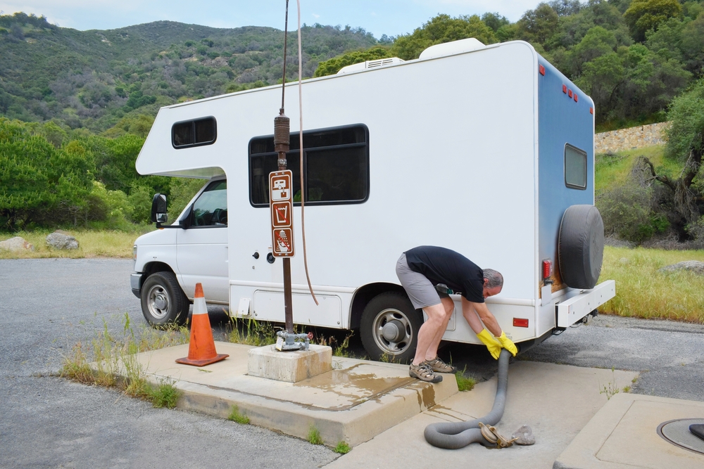 Man emptying RV toilet in dump station