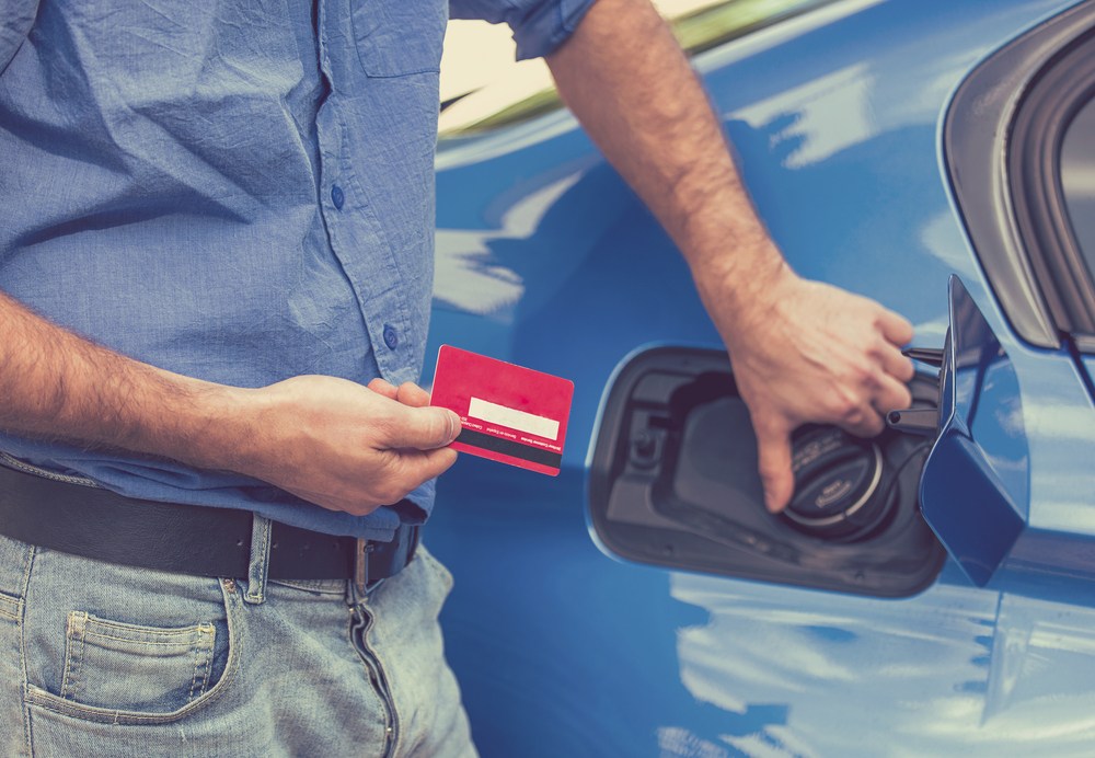 Driver with credit card ready to open the gas cap