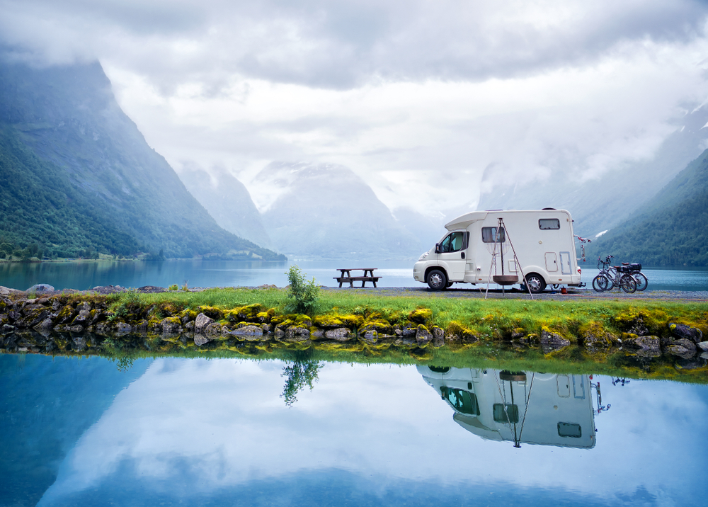 Fiberglass RV with fresh wax by a lake