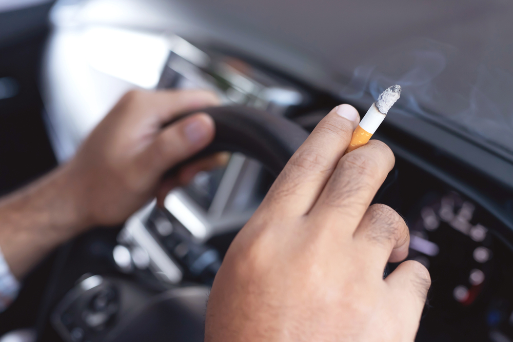 man with cigarette in a car