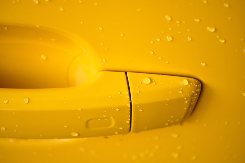 water droplets on surface of car paint