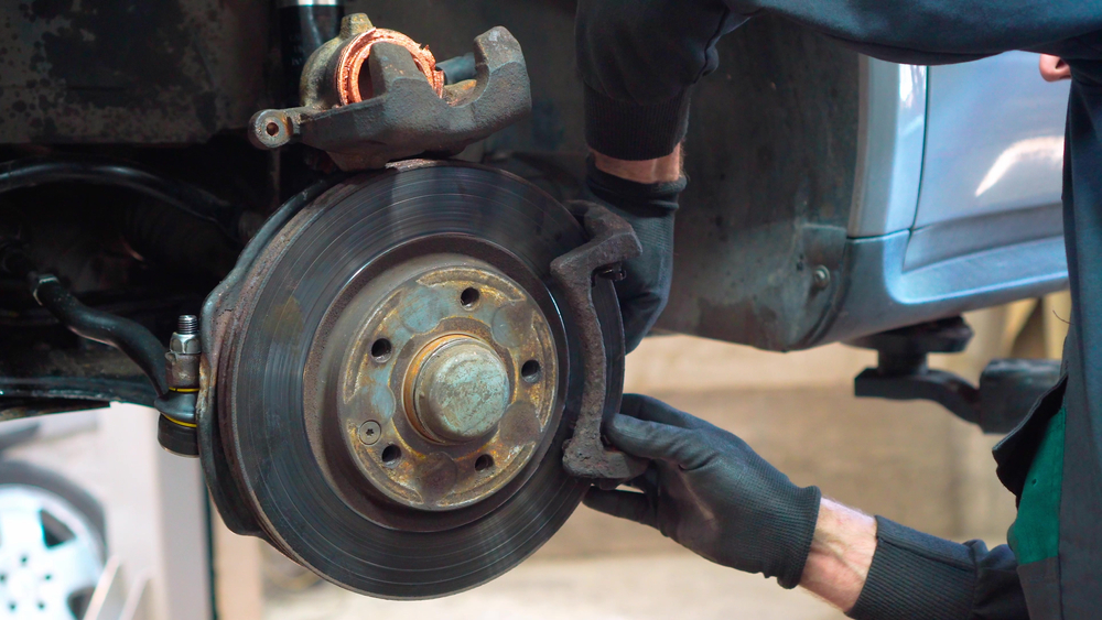 professional repairing a brake