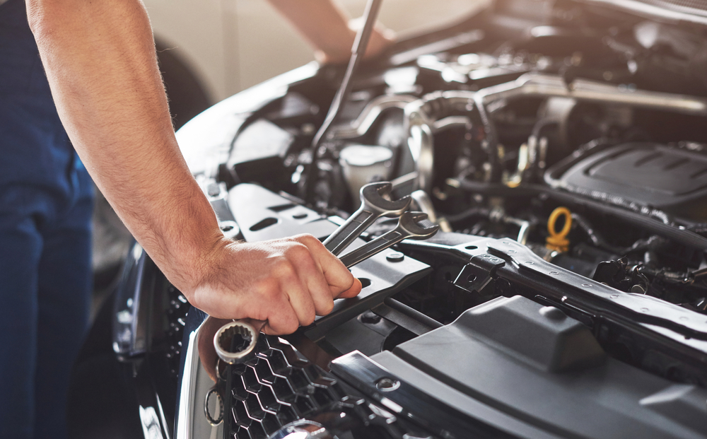 A car mechanic repairing a vehicle’s engine