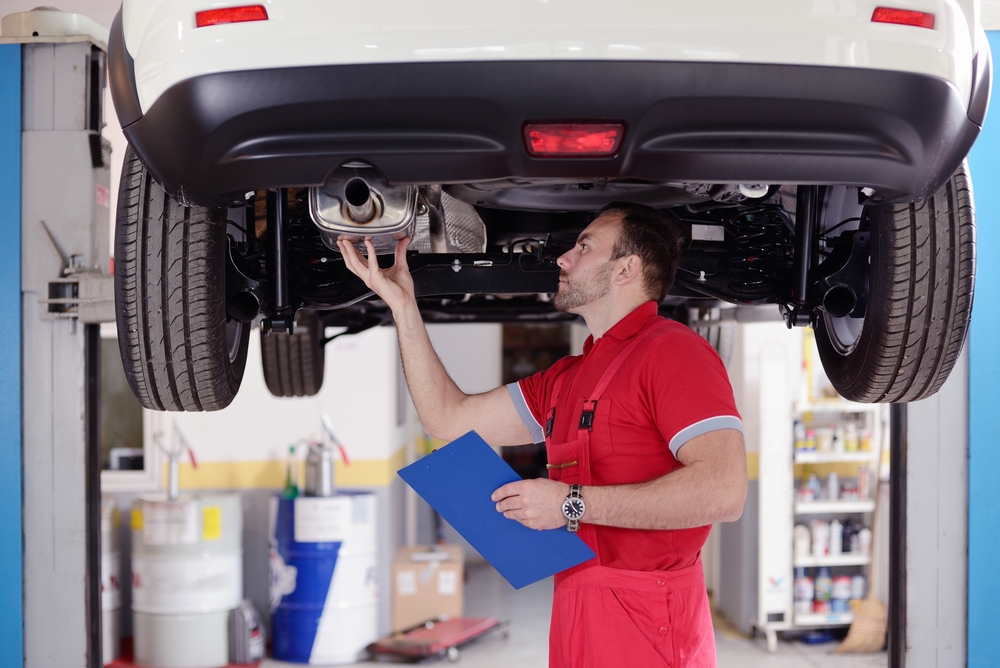 mechanic inspecting car exhaust