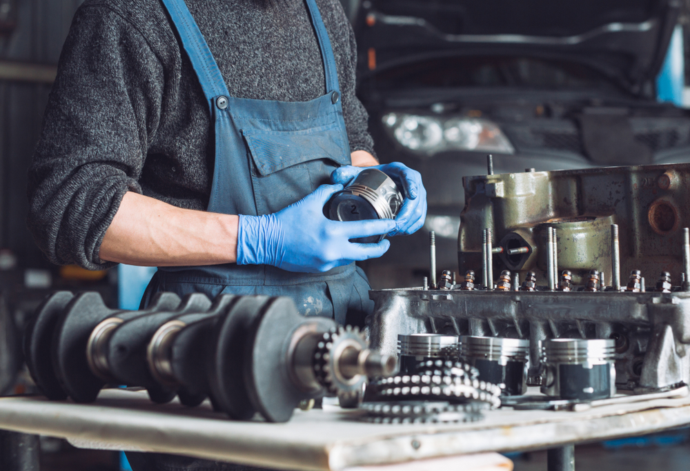 mechanic inspects internal engine components