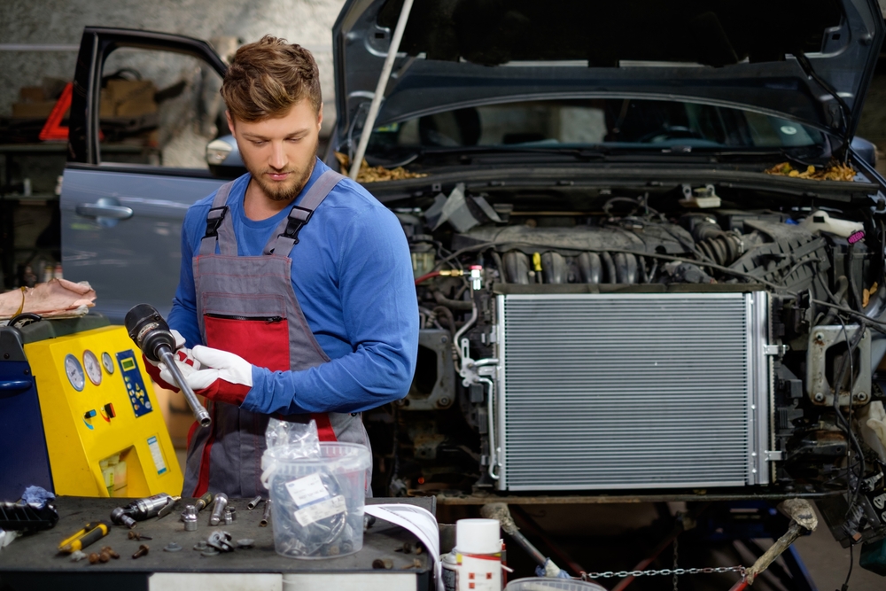 mechanic replacing a radiator