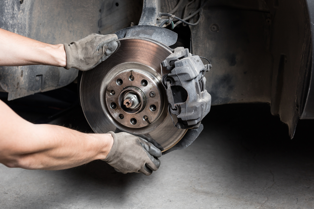 mechanic replacing brakes