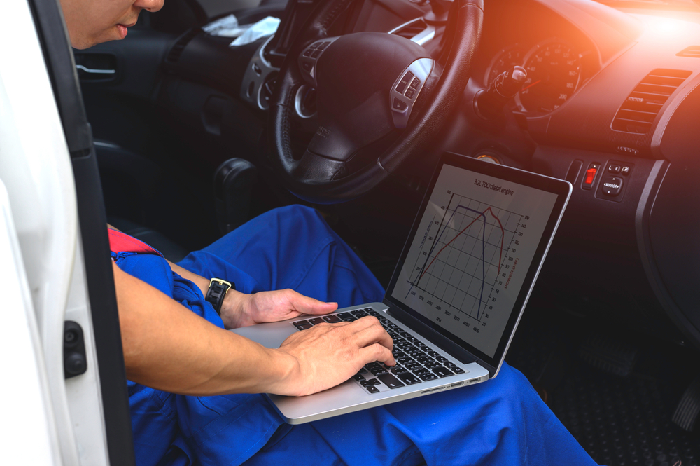 mechanic using a computer for diagnostics