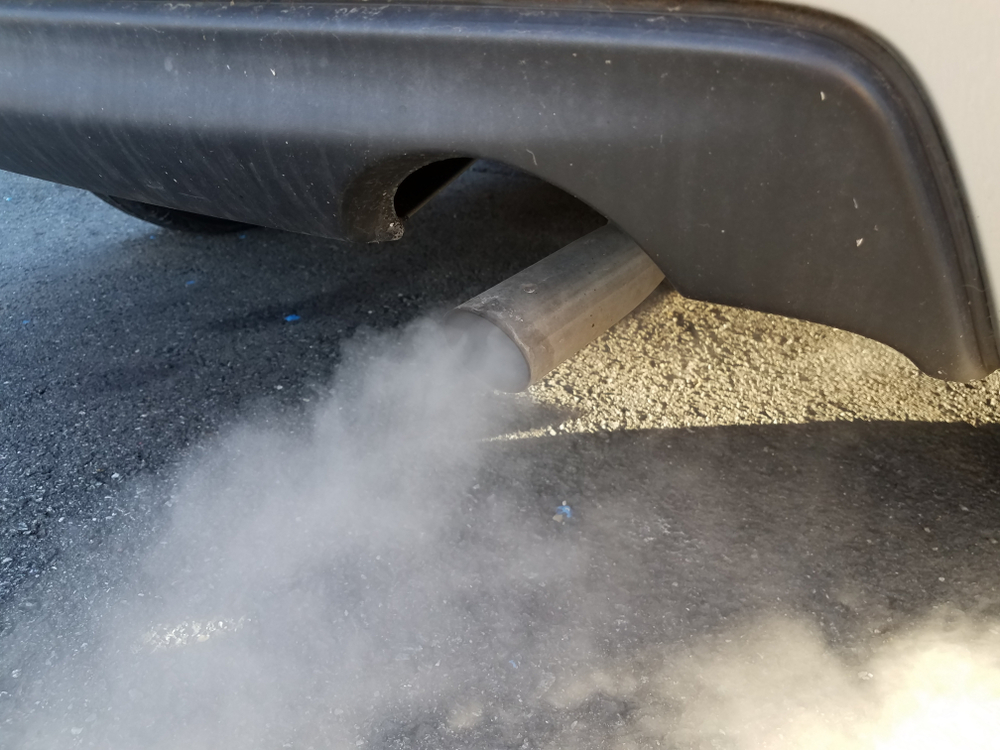 smoke comes out of a car’s exhaust pipe