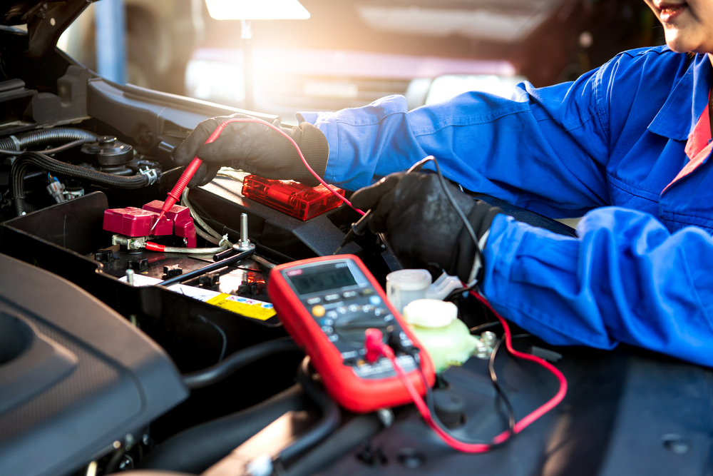 technician using multimeter to check electrical