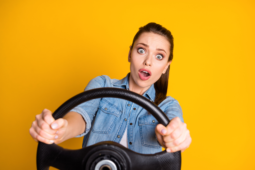 woman holding steering wheel