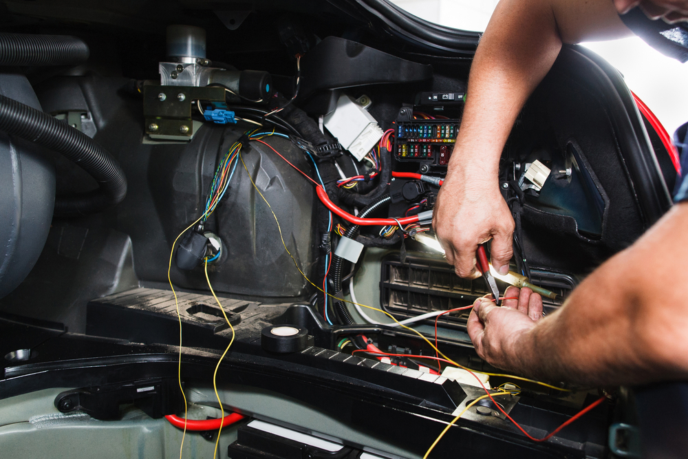 working on a car’s complicated electrical