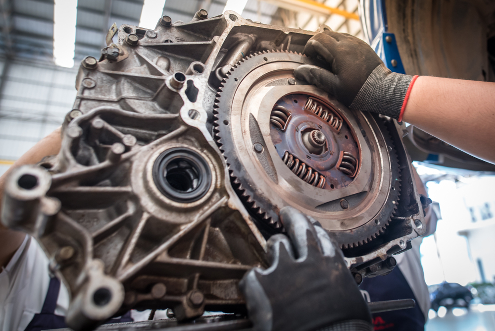 a mechanic fitting a dual mass flywheel to the engine