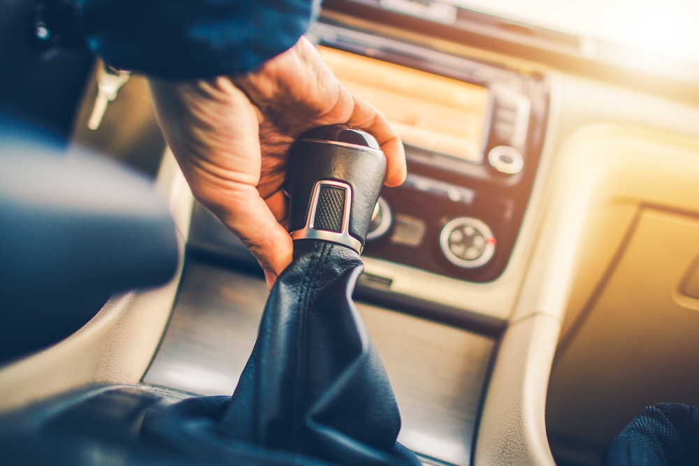 a person changing gear in a manual transmission car