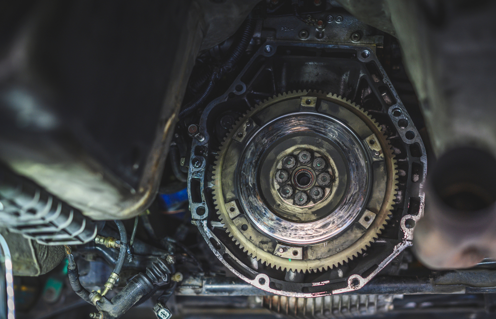 a worn flywheel sitting in the transmission housing