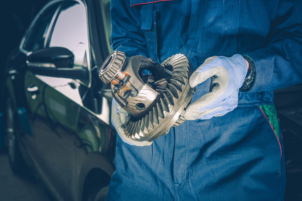 mechanic holding the inside of a differential