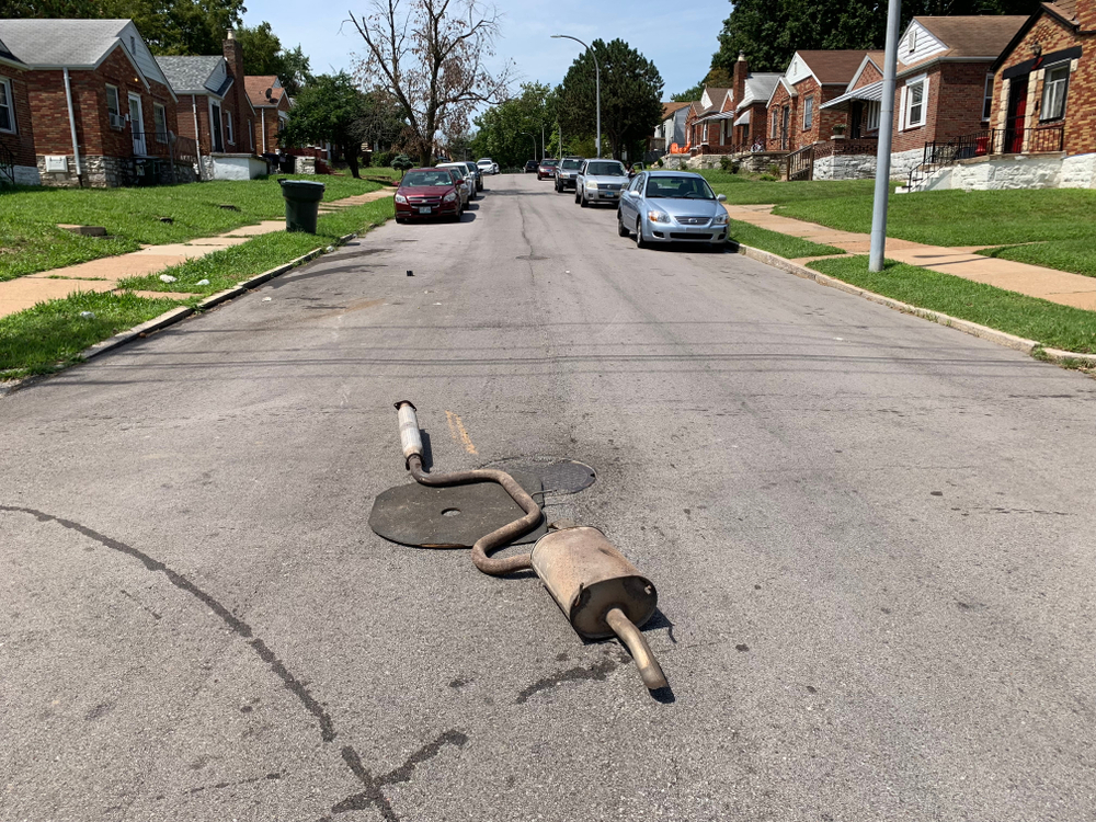 muffler and exhaust pipe laying on road