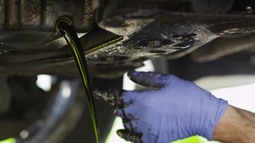 dirty oil pouring out of engine block