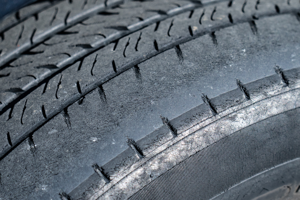 a car tire with uneven wear on the tread