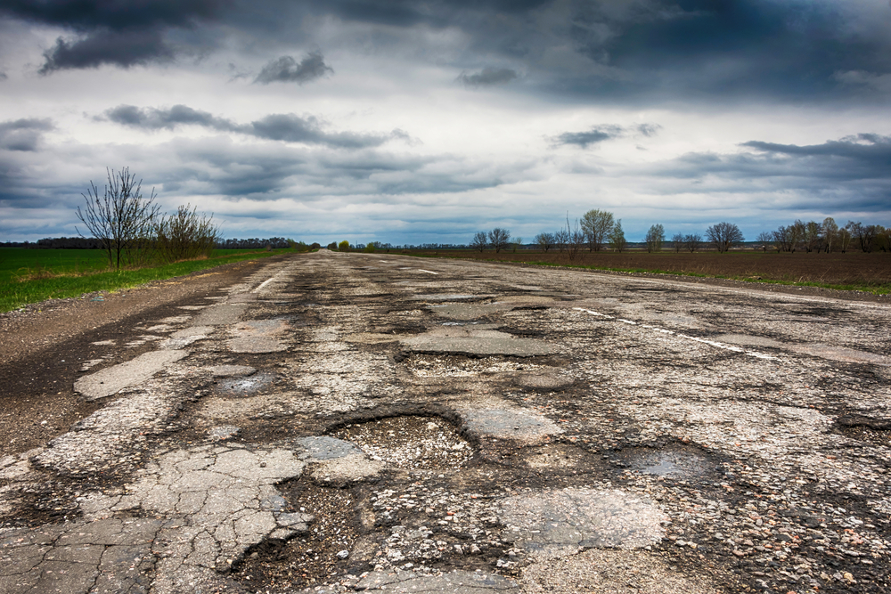 old road that's full of potholes that could lead to unbalanced tires